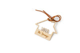 Wooden House shaped ornament cut with the house number and engraved with The Youngs with a Suede Tie placed on a white background