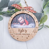Baby's Second Christmas Laser engraved Ornament with red ribbon on Holiday greenery background