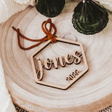 Personalized Wooden Last Name 2022 Christmas Ornament as shown a hexagon with "jones" in the middle and 2022 in the bottom right hand side