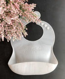 White Silicone toddler Bib with food catching pocket "personalized" laser engraved with child's name in cursive script