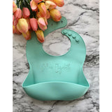Mint Rubber baby bib customized with a first and last name engraved into the bib on a marble background by Legacy and Light