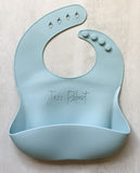 Soft blue Silicone toddler Bib with food catching pocket "personalized" laser engraved with child's name in cursive script