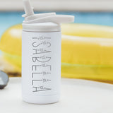 White color 12-ounce stainless steel, flip-top straw tumbler. The tumbler is laser engraved and personalized with the name of the child, the font has little flowers along the name. The tumbler is sitting on a white table with a yellow pool floaty in the background.