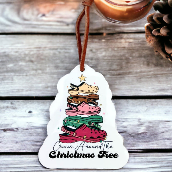 A Christmas tree made of Crocs Shoes on a white background with Crocin Around the Christmas tree printed below in a stylized font
