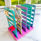 Colorful jewelry organizer with earrings on a marble surface