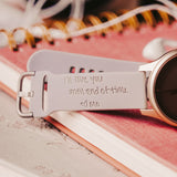 Silicone Watch band engraved with a personalized hand written note connected to a smart watch on a notebook