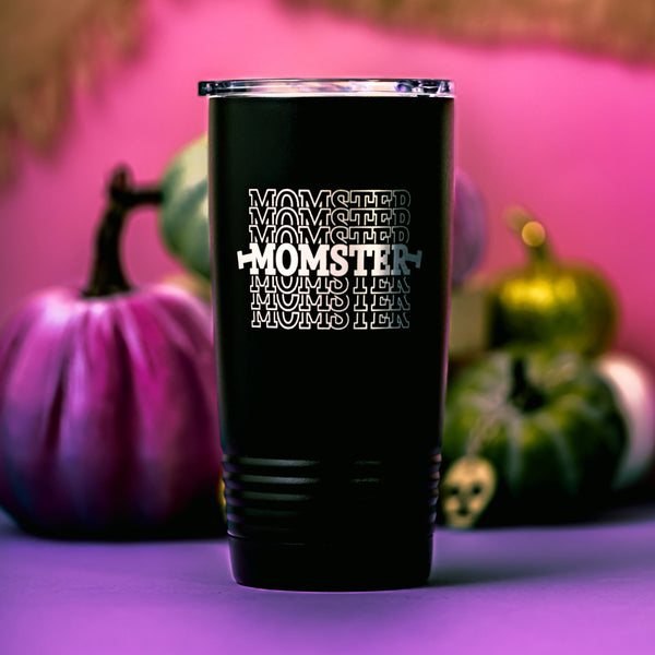 Black stainless steel tumbler with a cute Momster design laser engraved into the powder coating with a pink background