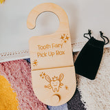 Wooden Tooth Fairy pick-up box with decorative elements on a textured surface.