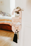 Wooden tooth fairy pick-up box with a tassel on a white door