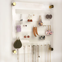 Clear Acrylic Earring and necklace holder with gold hardware shown with earrings and necklaces
