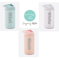 Three different color option shown for twelve-ounce flip-top straw tumblers displaying color options available in matte mint, opalescent white and matte blush by Legacy and Light.