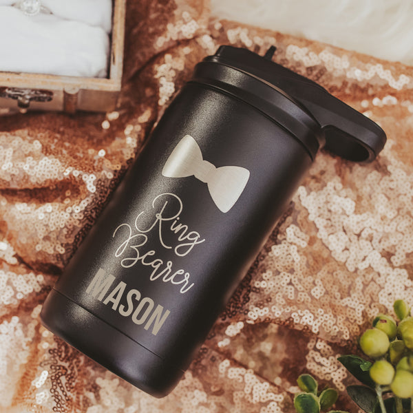 Black 12 oz kids water bottle gift from bride with ring bearer and bow tie laser engraved and personalized with name with greenery and sparkles  in the background