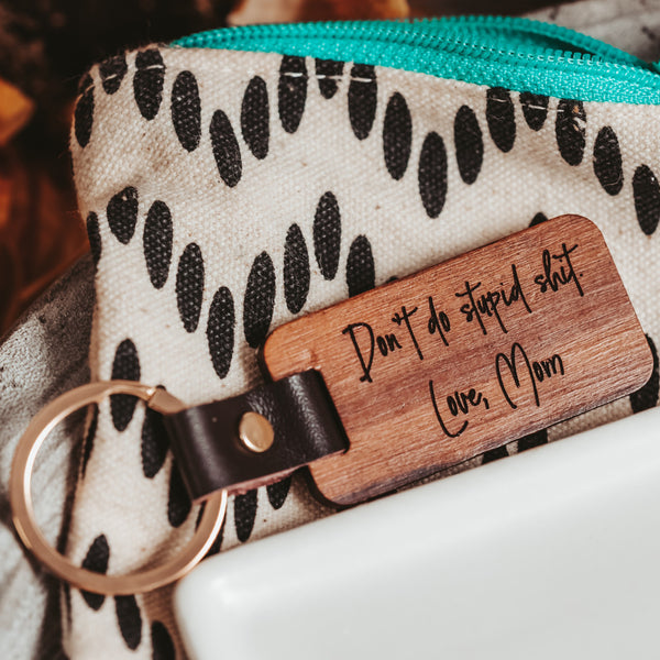 Wooden Engraved Don't Do stupid shit keychain on polka dot bag with teal zipper by Legacy and Light