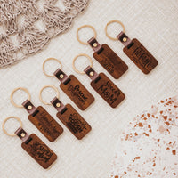 Seven Mom keychains lined up on linen background