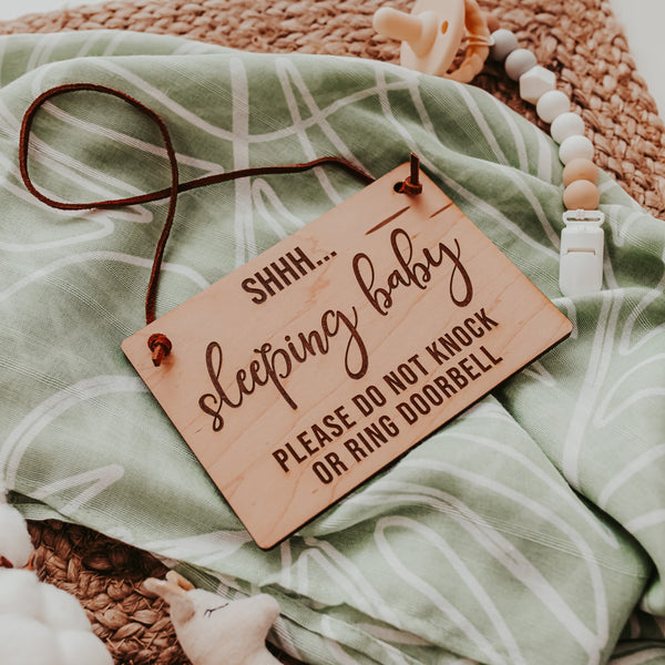 Wooden Hanging Sign with writing "SHHH...Sleeping baby Please do not knock or ring doorbell"  with a suede tie