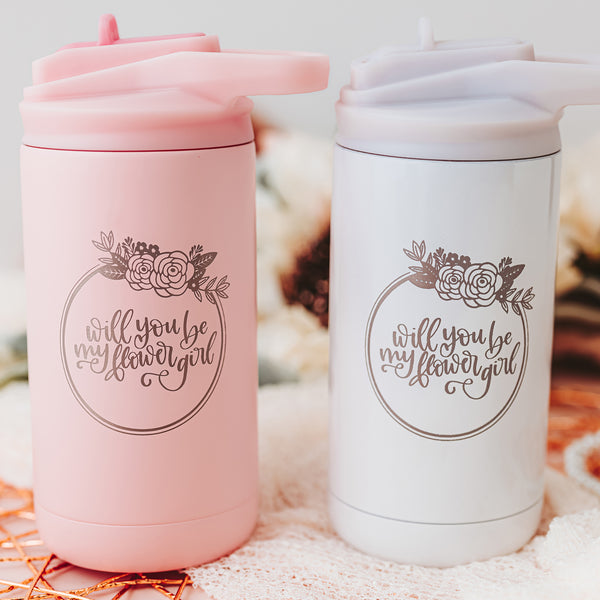 Two Twelve-ounce matte blush and opalescent white tumblers for cold beverages. Laser etched with "Will You be my Flower Girl"  encircled with a floral wreath on the front of the tumbler. 