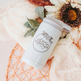 Opalescent white twelve-ounce hot and cold drink tumbler with flip up straw and the front is laser engraved with "Will You be my Flower Girl?" encircled with a flower wreath border.